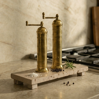 Ophelia brass mills styled on a Cojio travertine riser as part of a layered tiered tray display