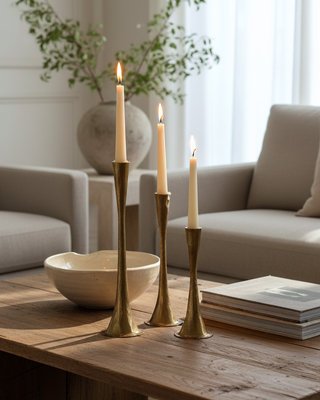 Decorative setup with candles on a wooden table in a living room.