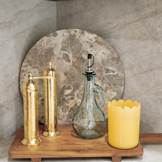 The Pepper + Vetiver Ophelia Greek brass salt and pepper mills styled with the Vera marble lazy susan in the kitchen of HGTV's Totally 90s House