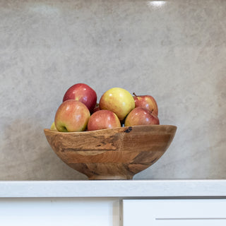 The Pepper + Vetiver Palmer Bowl holding apples on the counter of the kitchen in HGTV's Totally 90s House